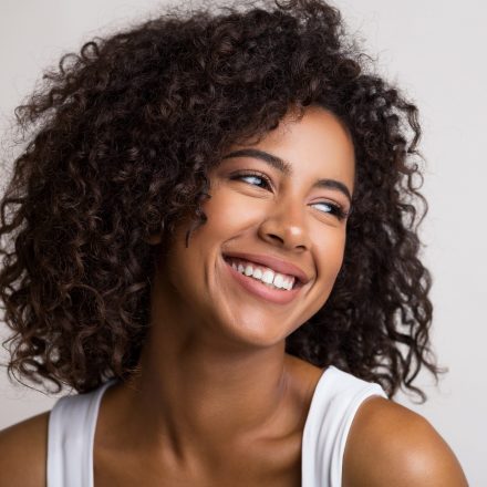 Beauty portrait of happy african american woman Beauty portrait of happy african american woman on light panorama background with empty space